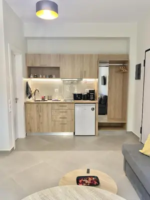 a kitchen with wooden cabinets and a white refrigerator at ATHENIAN Vibes in Athens