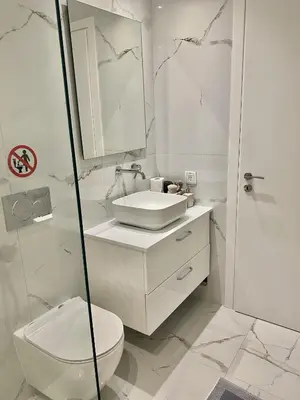 a white bathroom with a toilet and a sink at ATHENIAN Vibes in Athens