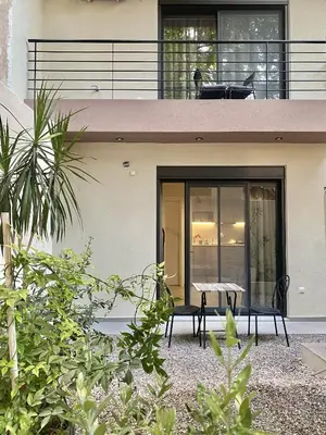 a house with a table and chairs on the balcony at ATHENIAN Vibes in Athens