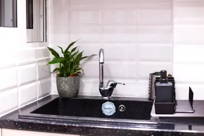 a kitchen sink with a faucet and a plant at Athens City Studio in Athens
