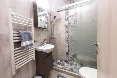 a small bathroom with a sink and a toilet at Athens City Studio in Athens