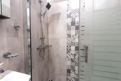 a bathroom with a shower with a glass door at Athens City Studio in Athens