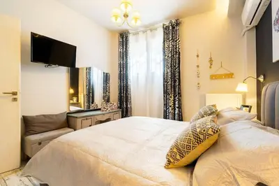 a bedroom with a bed and a tv and a couch at Diamond apartment in Athens