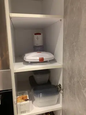 a cupboard with a blender and dishes in it at Diamond apartment in Athens