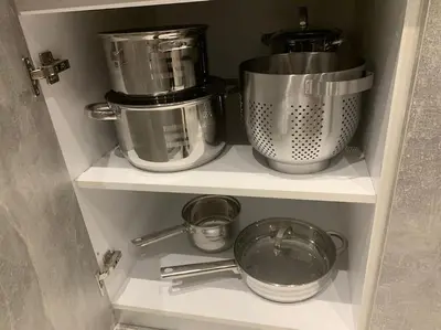 a pantry with pots and pans on a shelf at Diamond apartment in Athens