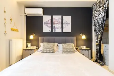 a bedroom with a large white bed with two pillows at Diamond apartment in Athens