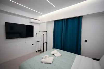 a bedroom with a bed with two white towels at Artemis Suite by Zeussuites in Athens