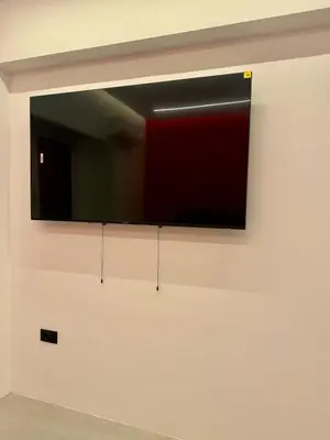 a television hanging on a wall in a room at Artemis Suite by Zeussuites in Athens
