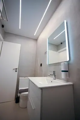 a bathroom with a sink and a mirror and a toilet at Artemis Suite by Zeussuites in Athens
