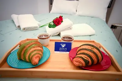two slices of bread on a tray on a bed at Artemis Suite by Zeussuites in Athens