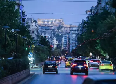 a group of cars driving down a busy city street at Artemis Suite by Zeussuites in Athens