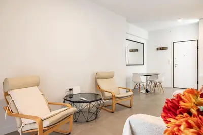 a living room with two chairs and a table at Bisou d' Athènes 1 in Athens