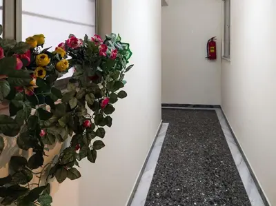 a hallway with a wreath of flowers on a wall at Bisou d' Athènes 1 in Athens