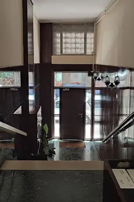 a hallway with a door and a staircase in a house at Bisou d' Athènes 1 in Athens