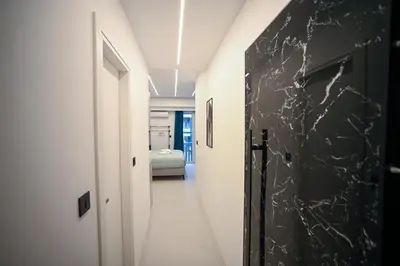 a hallway with white walls and a black wall at Erato suite by Zeussuites in Athens