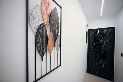 a group of feathers wall art in a hallway at Erato suite by Zeussuites in Athens