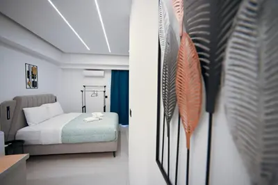 a bedroom with a bed and feathers on the wall at Erato suite by Zeussuites in Athens