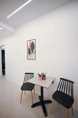 two chairs and a table in a room at Apollon Family Apartment by zeussuites in Athens