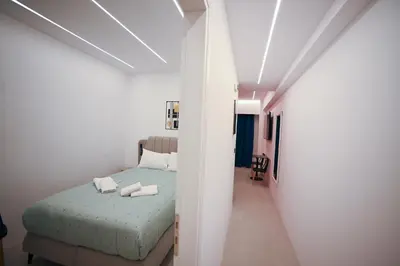 a bedroom with a bed with two towels on it at Museum Family Apartment by Zeussuites in Athens