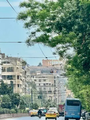a busy city street with cars and a blue bus at Museum Family Apartment by Zeussuites in Athens