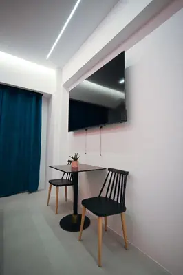 a dining room with a table and a chair at Museum Family Apartment by Zeussuites in Athens