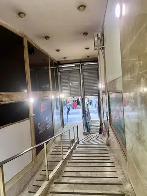 a stairway leading into a building with people walking down it at Aris Suite by Zeussuites in Athens
