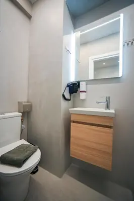 a bathroom with a toilet and a sink and a mirror at Aris Suite by Zeussuites in Athens