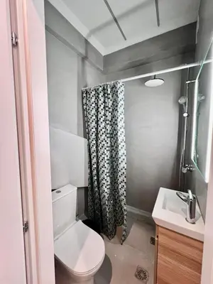 a bathroom with a toilet and a shower curtain at Aris Suite by Zeussuites in Athens