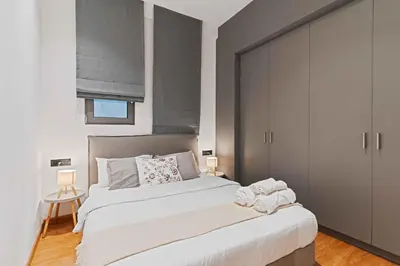 a bedroom with a large bed with towels on it at Ray the Second - 1BR, Exarcheia in Athens