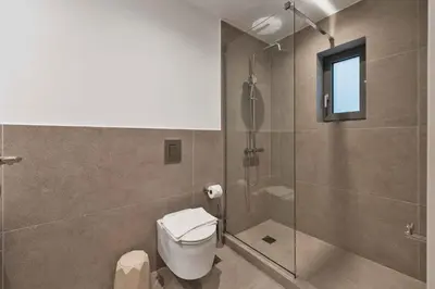 a bathroom with a toilet and a glass shower at Ray the Second - 1BR, Exarcheia in Athens