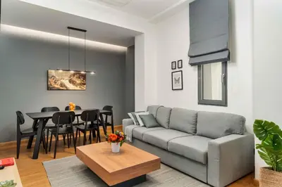 a living room with a couch and a table at Ray the Second - 1BR, Exarcheia in Athens