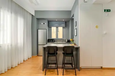a kitchen with two bar stools and a sink at Ray the Second - 1BR, Exarcheia in Athens