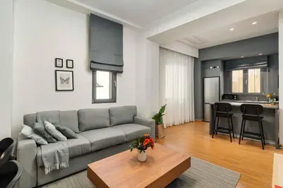 a living room with a couch and a table at Ray the Second - 1BR, Exarcheia in Athens