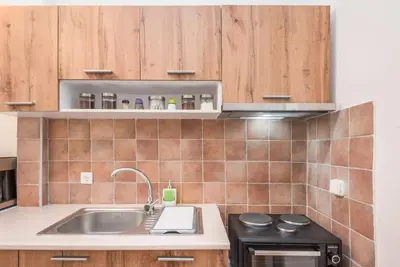 a kitchen with a sink and a stove at Beautiful central apartment next to the Metro in Athens