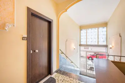 a door in a hallway with a red car in the window at Beautiful central apartment next to the Metro in Athens