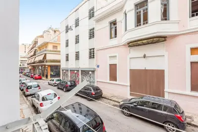 a view of a street with parked cars and buildings at Beautiful central apartment next to the Metro in Athens