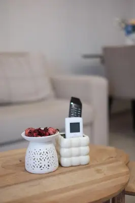 a table with a cell phone and a bowl of fruit at Cozy Hideaway Nearby Acropolis & Metro in Athens