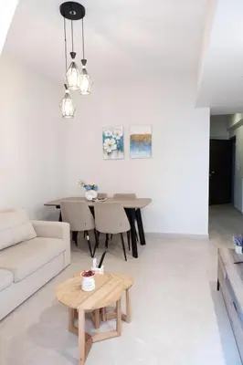 a living room with a couch and a table at Cozy Hideaway Nearby Acropolis & Metro in Athens