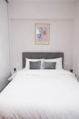 a large white bed in a white bedroom at Cozy Hideaway Nearby Acropolis & Metro in Athens