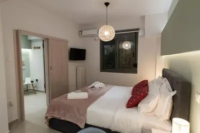 a bedroom with a bed with two pillows on it at Urban Maisons in Athens
