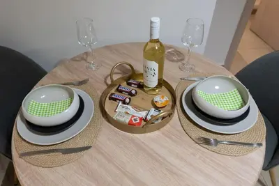 a table with a bottle of wine and a basket of food at Urban Maisons in Athens