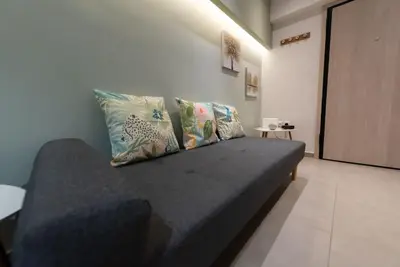 a couch with pillows on it in a room at Urban Maisons in Athens