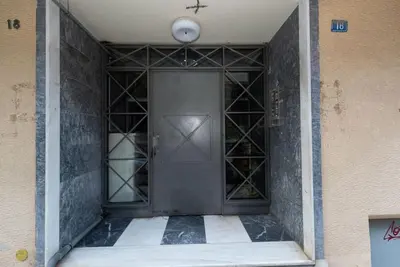 an empty corridor with a door in a building at Urban Maisons in Athens