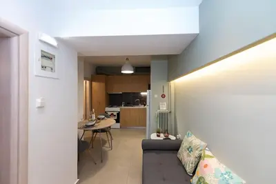 a living room with a couch and a table at Urban Maisons in Athens