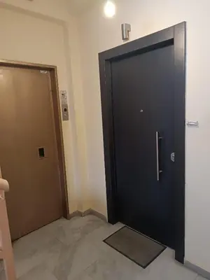 a black door and a brown door in a room at Central 2-Bedroom penthouse in Athens