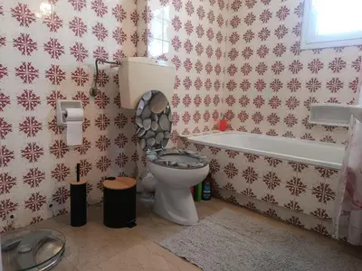 a bathroom with a toilet with the lid up at Central 2-Bedroom penthouse in Athens