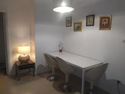 a white table and chairs in a room with a lamp at Central 2-Bedroom penthouse in Athens