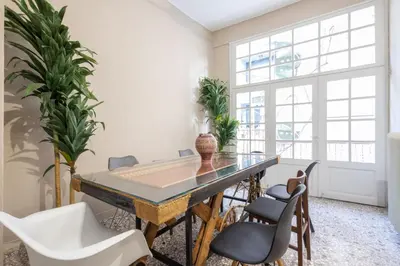 a dining room with a glass table and chairs at Vintage Acropolis Retreat Charming 3-Bdrm in Koukaki in Athens