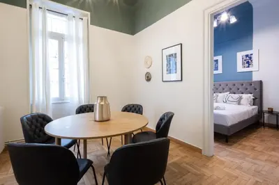 a room with a table and chairs and a bed at Vintage Acropolis Retreat Charming 3-Bdrm in Koukaki in Athens