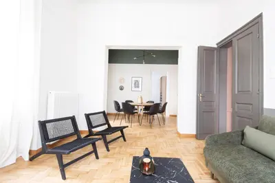a living room with a couch and chairs and a table at Vintage Acropolis Retreat Charming 3-Bdrm in Koukaki in Athens